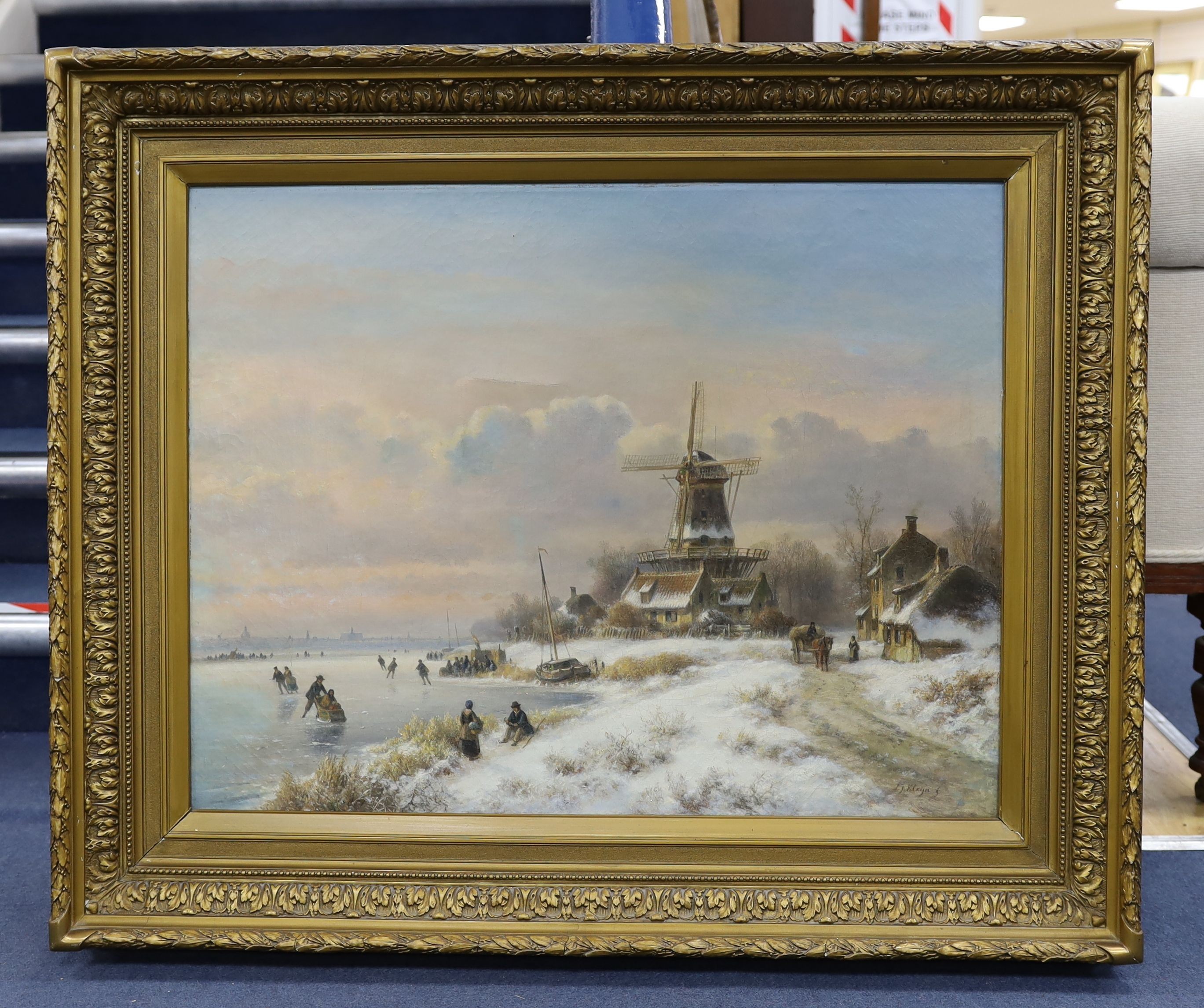 Lodewijk Johannes Kleijn (1817-1897), oil on canvas, Winter landscape with figures skating beside a windmill, signed, 59 x 76cm